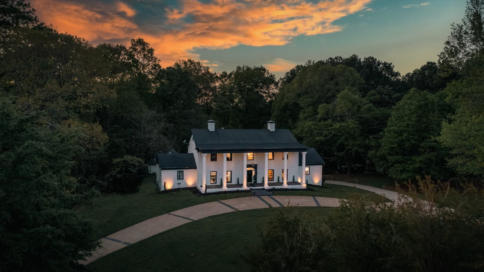 The columned estate exterior at golden hour
